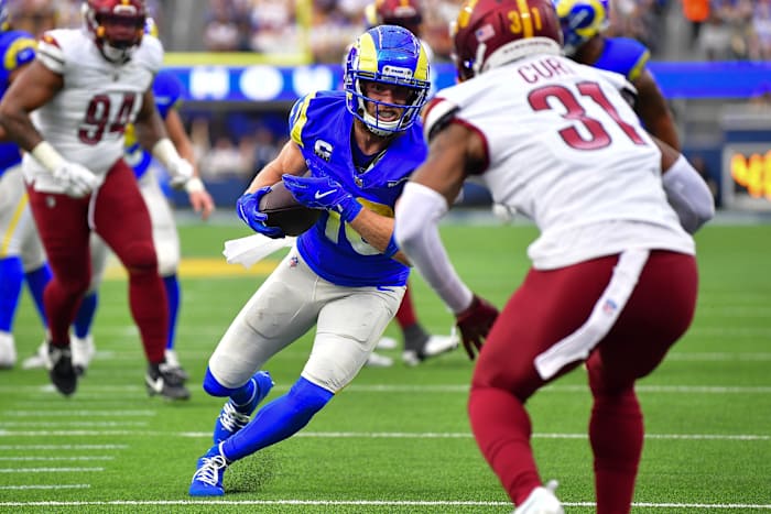 Dec 17, 2023; Inglewood, California, USA; Los Angeles Rams wide receiver Cooper Kupp (10) runs the ball against Washington Commanders safety Kamren Curl (31) during the first half at SoFi Stadium.